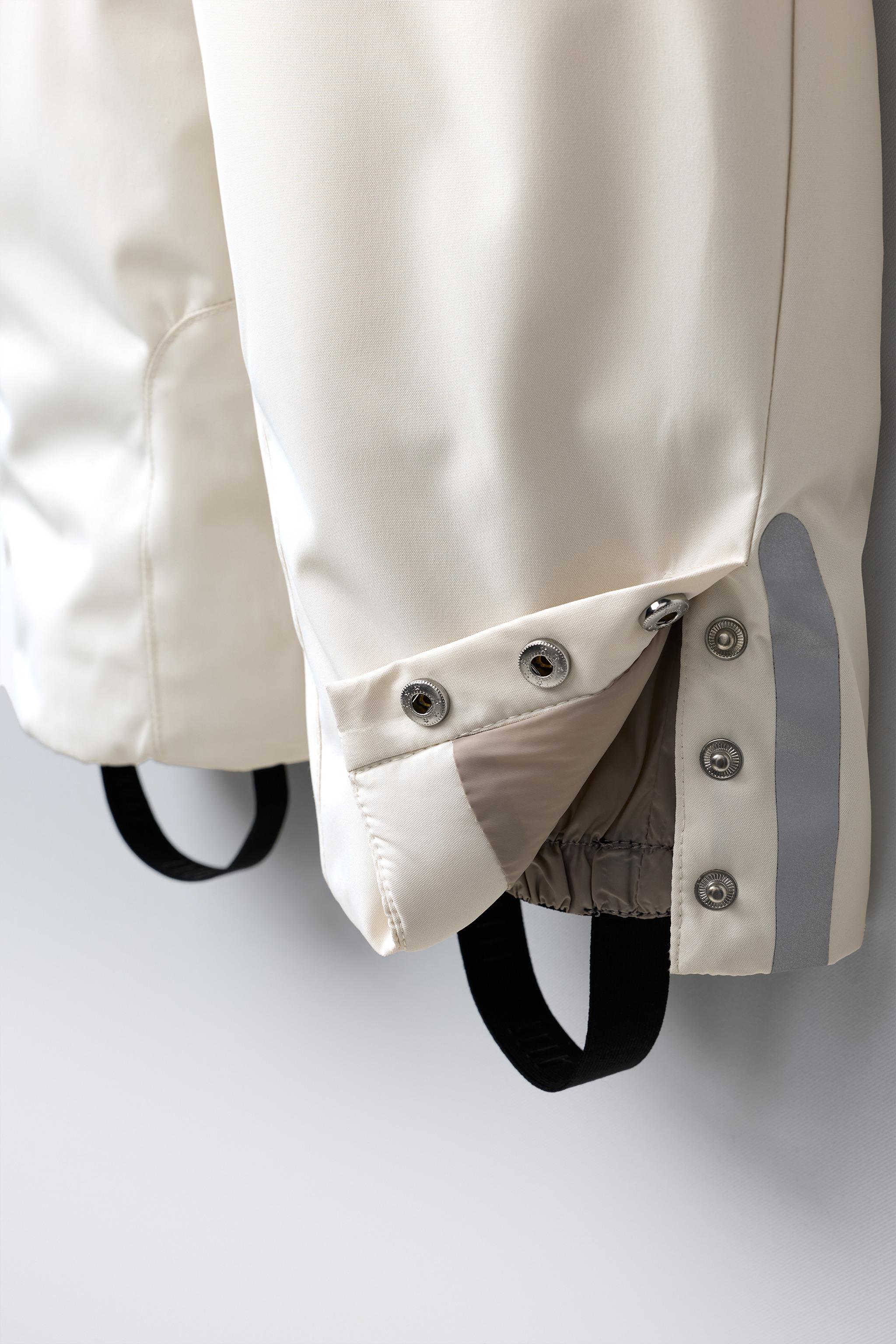 WATER RESISTANT AND WINDPROOF RECCO® SYSTEM SKI COLLECTION LONG JUMPSUIT WITH FAUX FUR HOODIE